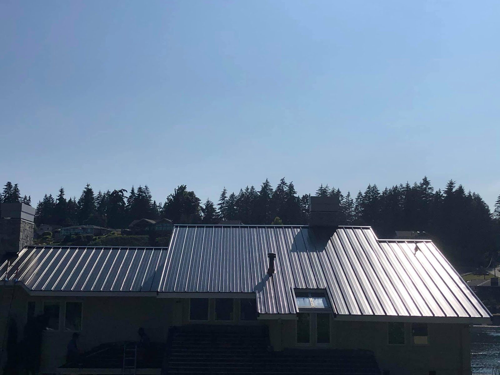 New standing-seam metal roof across connected rooflines
